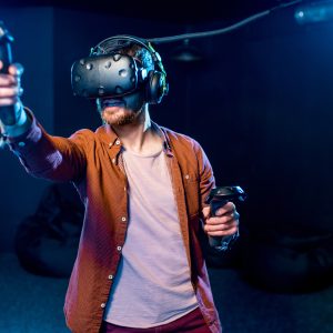 Man playing game with virtual reality headset in the club